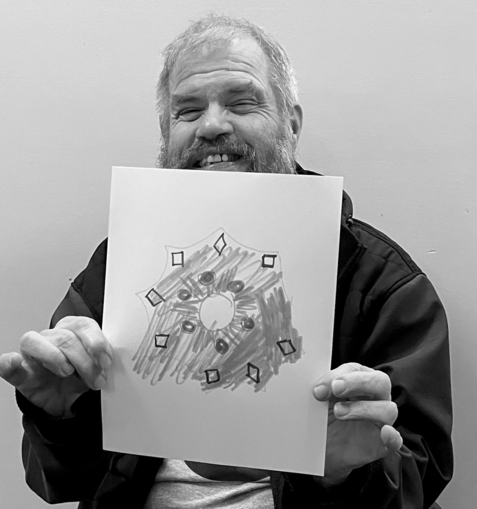 Bearded man holding a drawing