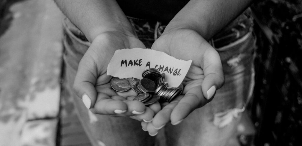 hands holding change with a note that says "make a change."
